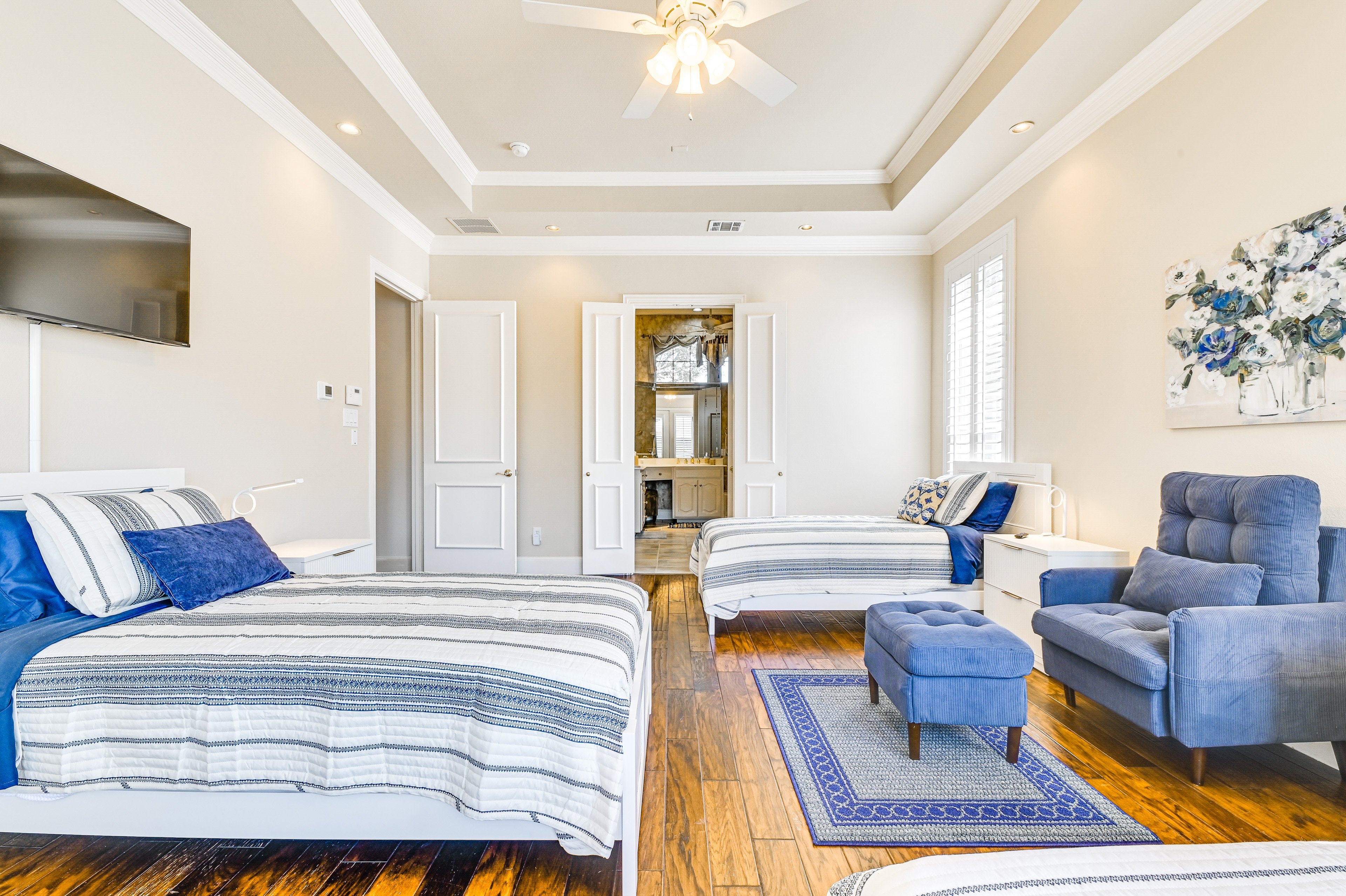Shared Bedroom 1 — view toward shared bath with blue and white coastal bedding
