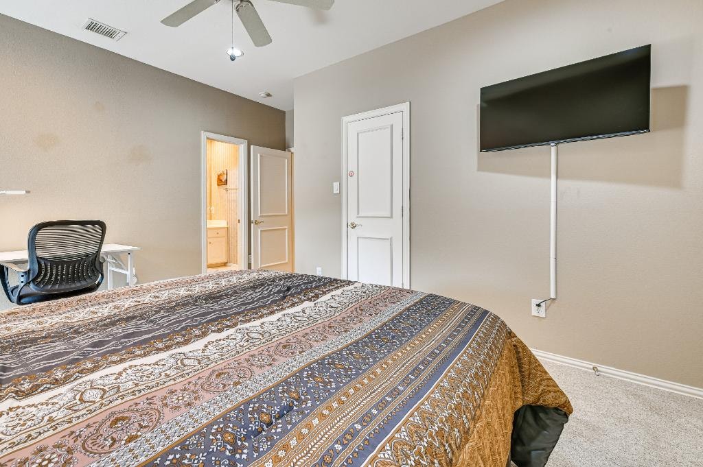 Private Suite Bedroom 5 — room with queen bed, Smart TV, and desk