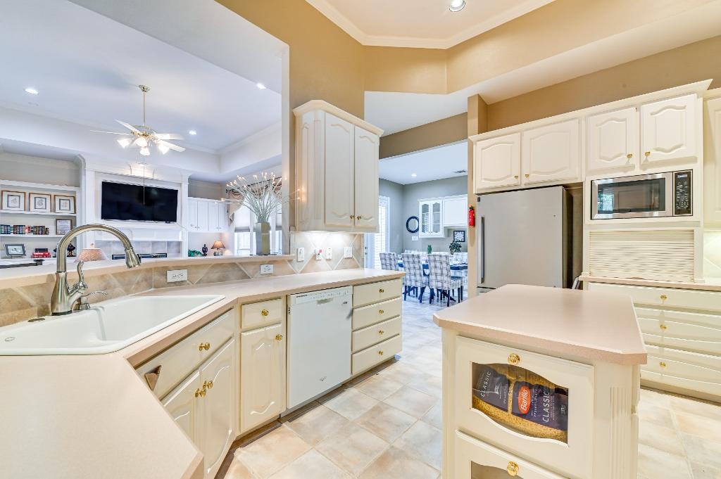 Kitchen at GYA Healthcare Housing with cream cabinetry and gold hardware