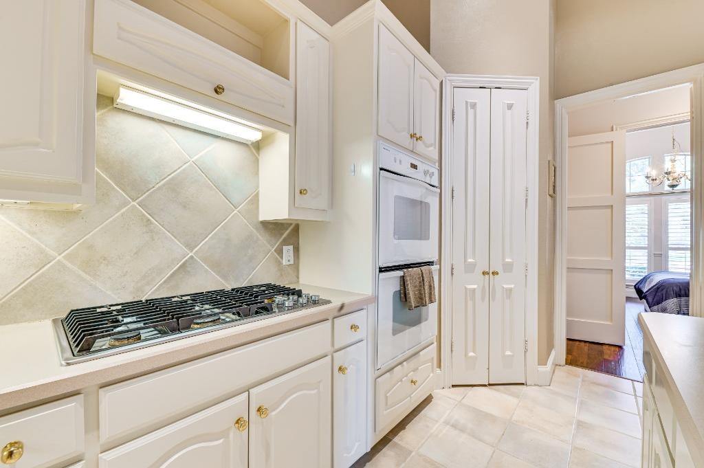 Kitchen interior at GYA Healthcare Housing with white cabinetry and brass fixtures